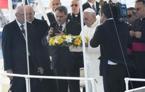 The Pope drops a wreath from an Italian coast guard vessel to remember the deceased migrants.