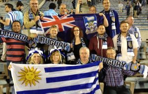 Falklands’ delegation members join with Uruguayan fans to lend their support.