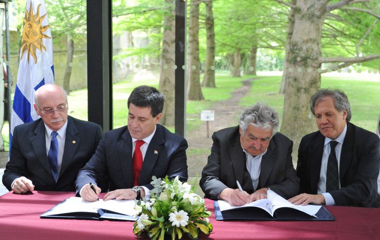 Cartes and Mujica sign the joint communiqué next to Foreign ministers Eloizaga and Almagro 