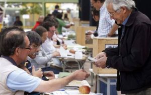 Chilean voters depositing their ballots, but an even greater number did not attend 