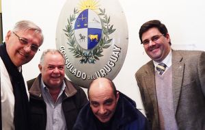 The delegates with the old sign of the Uruguayan Consulate in Stanley, which existed till about 1971 and is now in the museum