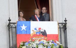From a balcony at Government house in Santiago, Bachelet addresses the crowd 