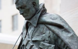 The Memorial is a bronze statue of a British soldier standing in front of an inscribed and carved obelisk of Portland stone on a base of Welsh slate