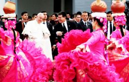 Pope's reception included women dancing in long swaying dresses as Guarani music played and people dressed as saints were carried on platforms.