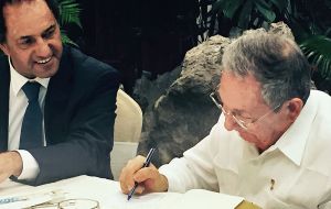 “For my friend Daniel, I will go to his inauguration on December 10 2015,” Castro wrote in a copy of his book “Raul Castro. A man in revolution”