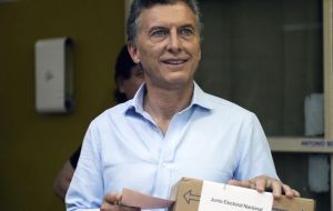 An enthusiastic Macri at the voting station before depositing the ballot for the awaiting media