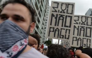 Demonstrators carried signs denouncing the rise in public transport fares which took effect in the city on Saturday. 