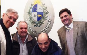 Trobo, together with other Uruguayan lawmakers during a visit to Stanley, next to the coat of arms from the former Uruguay consulate in Stanley