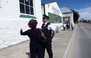 A cruise visitor requesting indications from a local official on a sunny summer day 