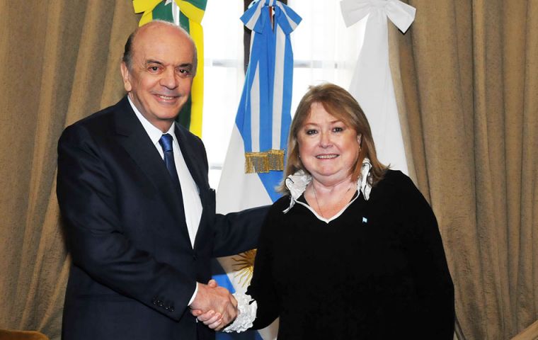 Jose Serra, Brazil's new foreign minister shakes hands with Susana Malcorra at the San Martin Palace