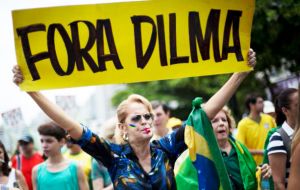 At the Rio rally some with Brazil's flag draped over their shoulders and  wearing the national colors of yellow and green, chanted “Out Dilma! Out corruption!”