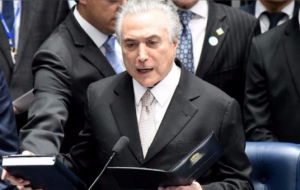 Temer took the oath of office in the Senate surrounded by his cabinet members and said that when the steps down in 2018 he wants to be applauded by the people.