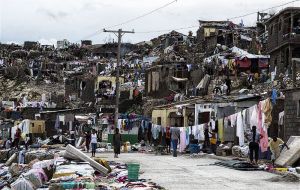 Aerial footage showed a ruined landscape of metal shanties with roofs blown away, downed trees everywhere and mud from overflowing rivers covering the ground.