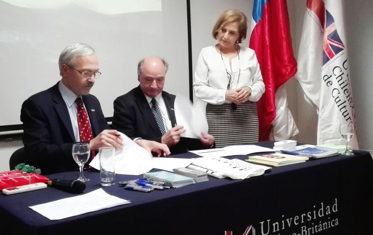 MLA Dr. Elsby signs the MOU with Pedro Pfeffer, (center) President of the Executive Council, while UCBC Vice-Chancellor Maria Cristina Brieba looks on.