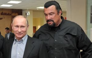 Russian President Vladimir Putin hands in Steven Seagal his new Russian passport