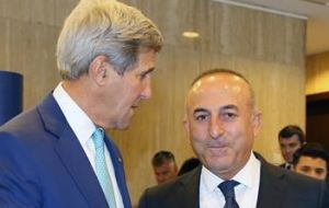 US Secretary of State John Kerry (left) discussed Monday's killing of the Russian Ambassador to Ankara with his Turkish counterpart Mevlut Cavosoglu (right) on the telephone 