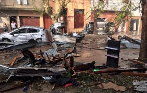 The Uruguayan president visiting the devastates areas of the town of San Carlos, where a woman died and dozens of roofs and power lines were blown 