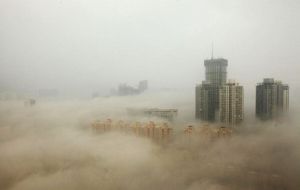 Beijing from the air as smog blankets the city. China has ordered hundreds of factories to close and to restrict motorists to cut emissions. 