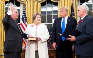 The former Exxon CEO Rex Tillerson takes the oath of office next to his wife, Vice president Pence and president Donald Trump   