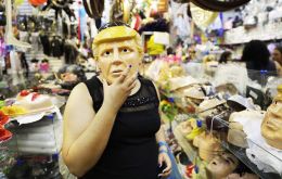  With his blond hair and his orange-tinted face, a Trump mask is prominently featured in the display window of an enormous store selling all sorts of costumes