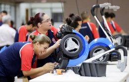 Dark-blue electric scooters assembled by 20 workers at the Estrela factory, known as a “maquila”, will be shipped across the Paraguay border to Brazil 