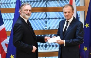 European Council President Donald Tusk being handed the letter by UK permanent representative Tim Barrow in Brussels