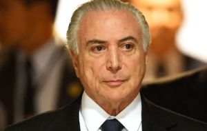 Brazilian President Michel Temer arrives at a signing ceremony in Brasilia on Monday. The country's prosecutor general has requested formal corruption charges against Temer. 