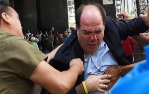 Julio Borges said on Twitter that 108 journalists, as well as students and visitors, were among those stuck inside. Borges also named five of the lawmakers injured. 
