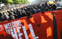 Throughout the afternoon and night, police used water cannons as protesters threw bottles and smoke bombs during the anti-capitalist Welcome to Hell march