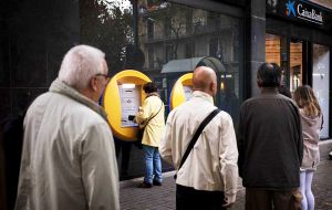 On Friday morning, dozens of people were lining up at a CaixaBank branch in central Barcelona, most of them withdrawing 150 or 160 Euros from ATMs.