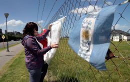 “Strength for Argentina. We trust in God. We are waiting for you,” read a message inscribed on a celestial blue-and-white Argentine flag hanging on the fence. 