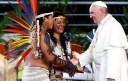 Bare-chested and tattooed native families, many sporting feathered and beaded headgear, interrupted Francis with applause, wailing horns and beating drums