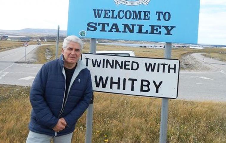 Jorge Lidio Viñuela during a visit to the Falkland Islands, pictured at an iconic signboard at the entrance of Stanley 