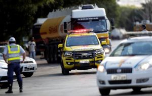 With gas stations low on fuel, police and military forces have been escorting fuel convoys to supply ambulances, police vehicles and buses for public transportation
