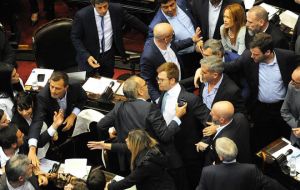 Inside the building the session in the lower house was temporarily suspended after some lawmakers scuffled and exchanged insults.