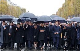 Macron and dignitaries walked to the Tomb of the Unknown Soldier, a memorial to France's fallen under the Arc de Triomphe, in the rain under black umbrellas (Pic AP)