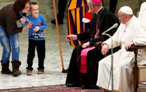 The boy’s mother briefly spoke to the pope as she tried to pull the child away, saying that he was mute. Pope Francis told her to let him carry on playing 