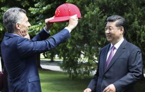 Macri also put a red polo helmet emblazoned with China's flag on Xi's head.
