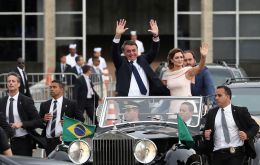 President Bolsonaro and wife Michelle are cheered as they rode in the open topped Rolls Royce  