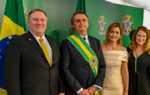 US Secretary of State Mike Pompeo embraces the Brazilian president during the official ceremony presenting foreign representatives    