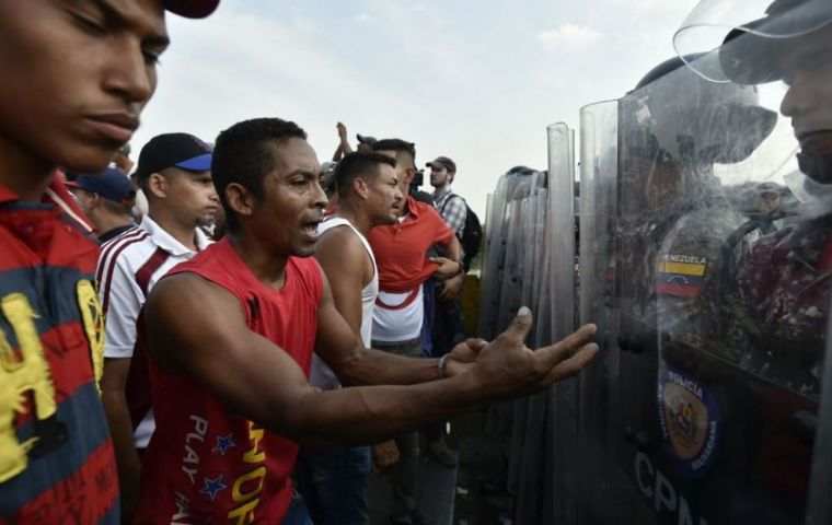 At least four people died in clashes between civilians and troops and armed groups, “colectivos” loyal to Mr Maduro, including a 14-year-old boy. (AFP)
