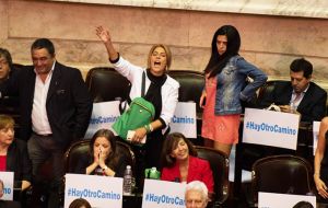 Opposition lawmakers held up posters saying “Macri Out” and “There is another way”. Others interrupted with shouts of “Liar.”