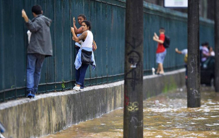 The unusually heavy rain began on Monday evening and continued into Tuesday, triggering widespread flash flooding that turned some streets into raging rivers