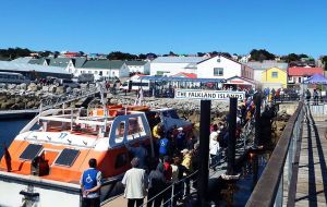 Hundreds of cruise visitors take over the streets of Stanley during a sunny day
