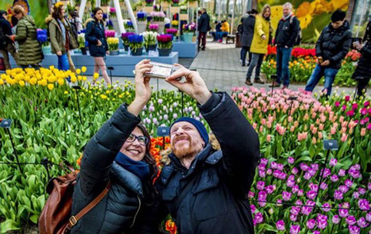 Dutch Tourism will stop promoting Netherlands as a holiday destination because its main attractions, canals, tulips, and windmills, are becoming overcrowded  (Robin Utrecht/AFP/Getty Images) 