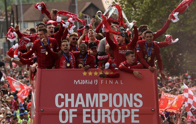  Supporters turned Liverpool into a sea of red as the open-top bus carrying coach Jurgen Klopp and his victorious players edged through the city