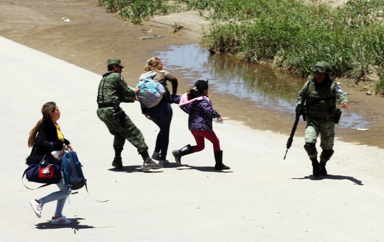 President Lopez Obrador, has come under fire over an AFP journalist's images of heavily-armed National Guardsmen forcibly detaining two women and a girl. Pic: AFP