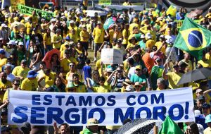 Demonstrators dressed in Brazil's national colors of yellow and green took to the streets in 27 cities, Brasilia, Rio de Janeiro and Sao Paulo, in support for Moro