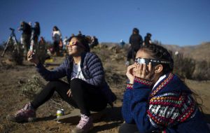 People in South America preparing for the total solar eclipse with solar glasses and solar filters. 