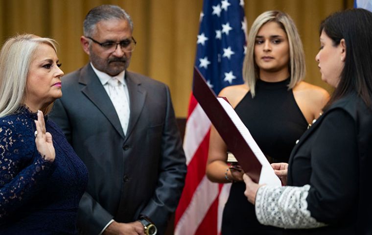 The island's justice secretary, Wanda Vazquez, was sworn in as governor at the supreme court in San Juan